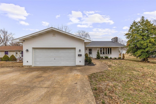 ranch-style home featuring a garage, a chimney, a front lawn, and concrete driveway