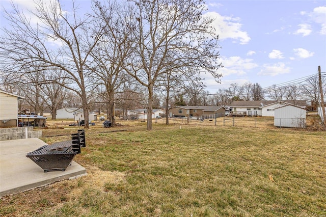 view of yard with an outdoor fire pit, fence, and a patio