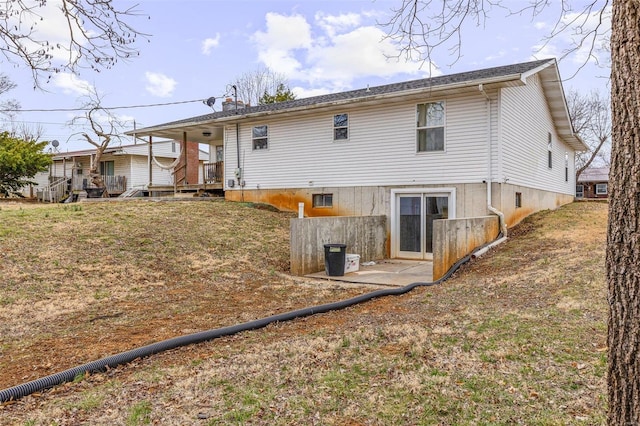 back of property with a patio and a yard