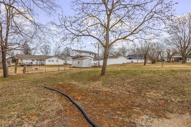 view of yard featuring a residential view and fence