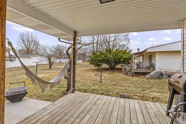 deck with a grill and a yard