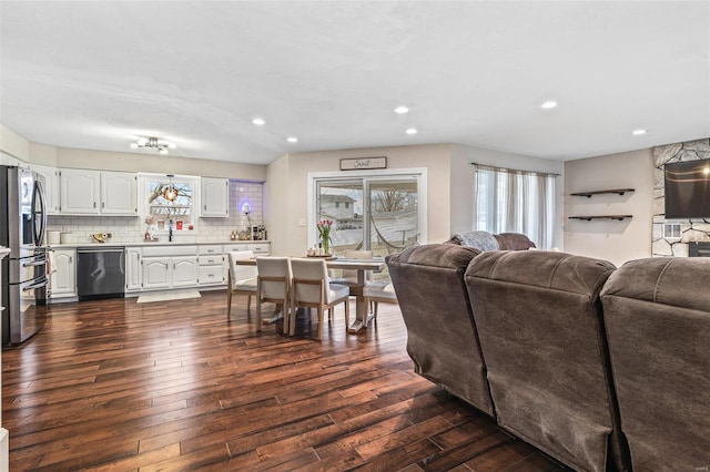 living room with recessed lighting and dark wood finished floors