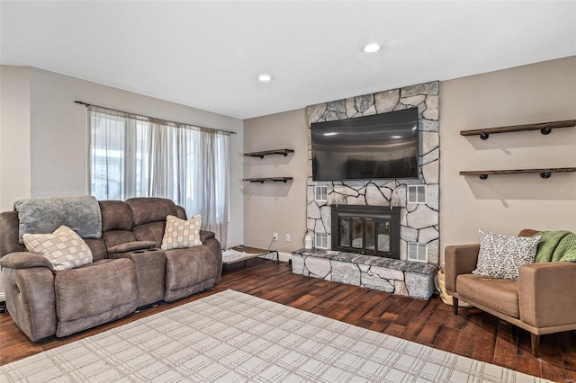 living room featuring a fireplace, wood finished floors, and recessed lighting