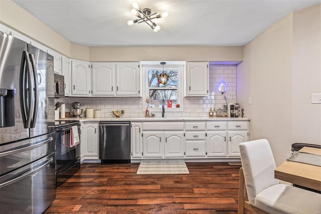 kitchen featuring electric range, a sink, light countertops, stainless steel fridge with ice dispenser, and dishwasher