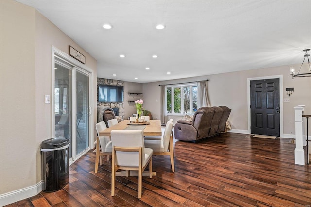 dining room with dark wood-style floors, baseboards, a notable chandelier, and recessed lighting