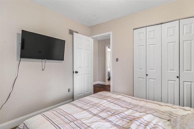 unfurnished bedroom with a closet, visible vents, and baseboards