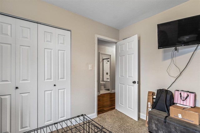 carpeted bedroom with baseboards and a closet