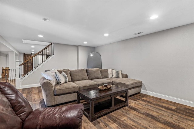 living area featuring recessed lighting, wood finished floors, visible vents, baseboards, and stairs