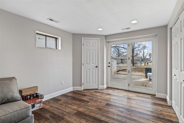 sitting room featuring visible vents, baseboards, and wood finished floors