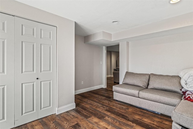 living area featuring dark wood-style flooring and baseboards