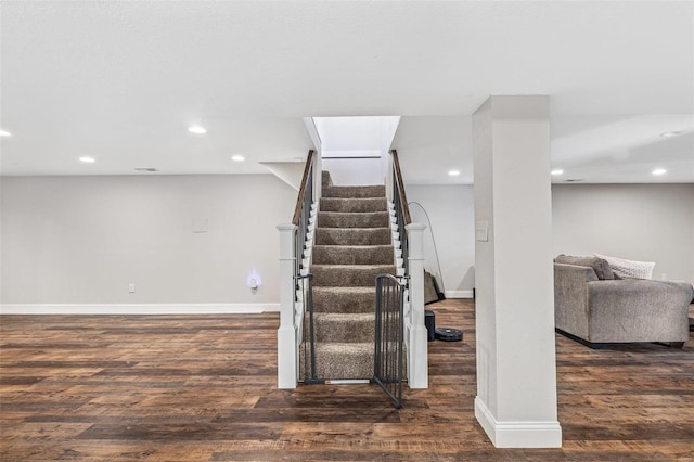 stairway featuring baseboards and wood finished floors