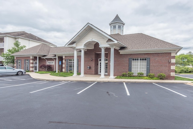 view of building exterior with uncovered parking