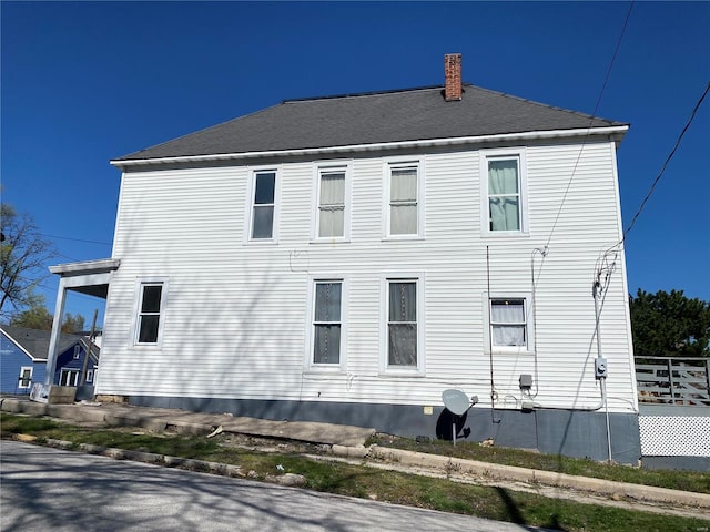 view of side of home featuring a chimney