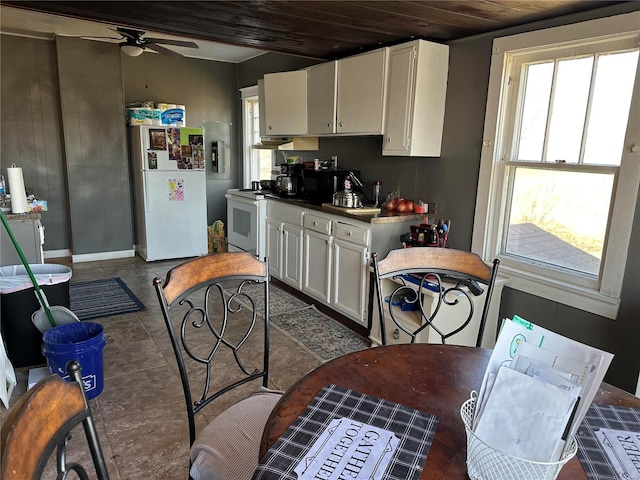 kitchen featuring a ceiling fan, white appliances, a healthy amount of sunlight, and white cabinets