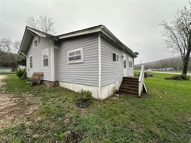 view of side of property with a yard
