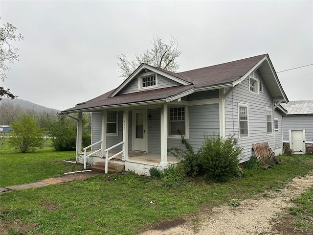 bungalow-style house featuring a porch and a front lawn