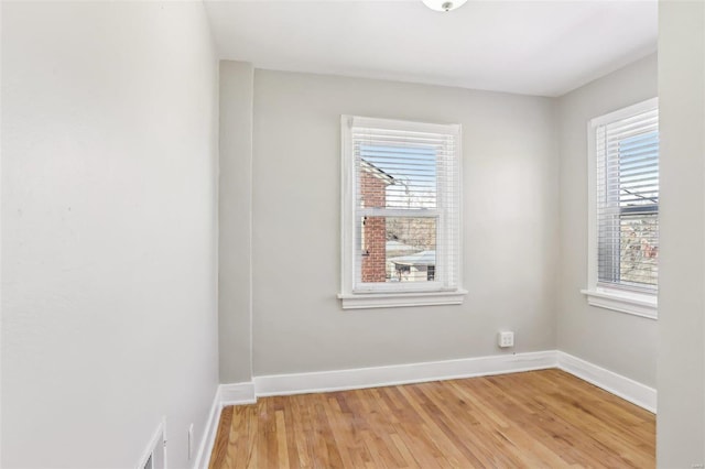 empty room featuring light wood-style floors and baseboards