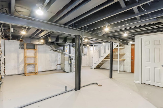 unfinished basement featuring heating unit and stairway