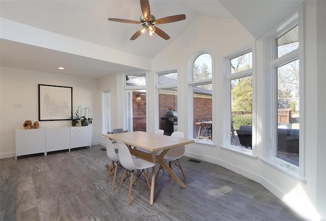 dining area featuring lofted ceiling, visible vents, and baseboards