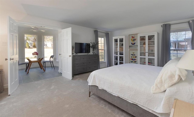 bedroom featuring multiple windows and carpet flooring