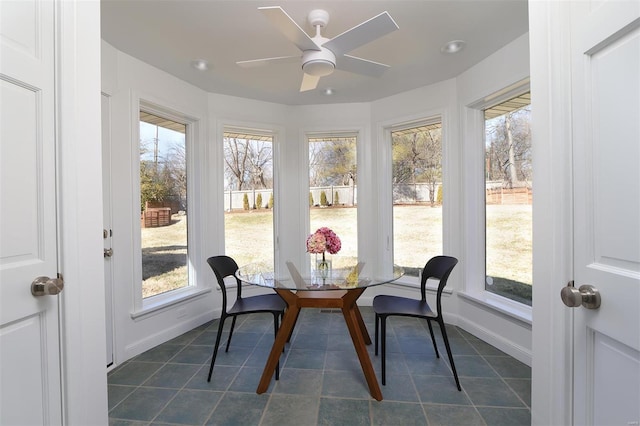 sunroom with a wealth of natural light and ceiling fan