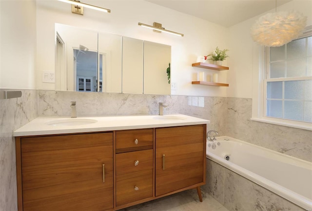 bathroom featuring a garden tub, double vanity, a sink, and tile walls