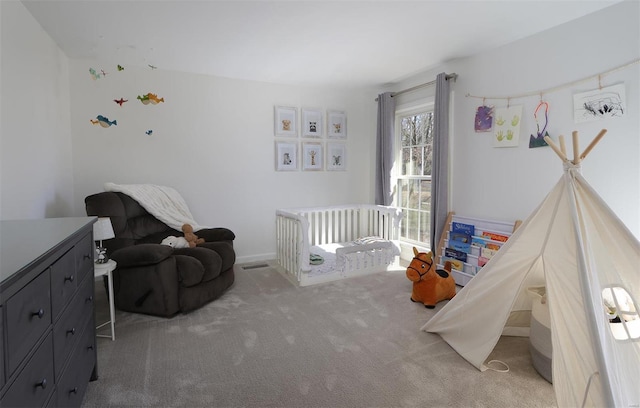 bedroom with carpet floors and a nursery area