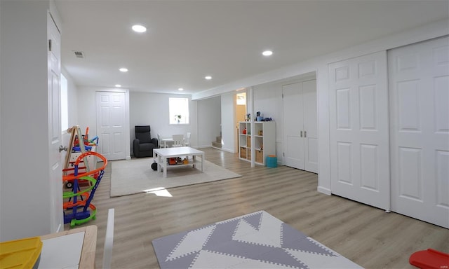 playroom featuring wood finished floors, visible vents, and recessed lighting