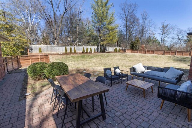 view of patio / terrace with outdoor dining area, a fenced backyard, and an outdoor living space