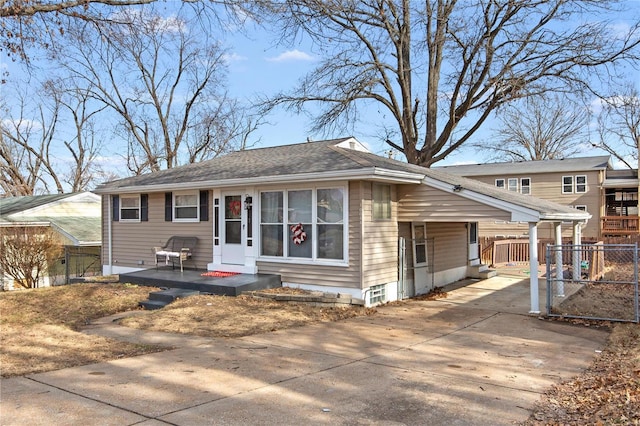 view of front of house with a carport, fence, and concrete driveway