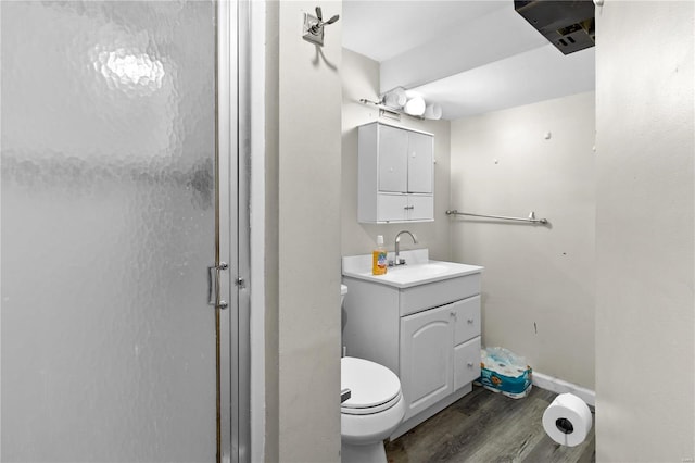 full bath featuring toilet, a stall shower, wood finished floors, and vanity