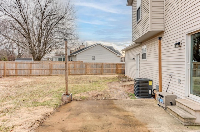 view of yard with a patio area, central AC, and fence