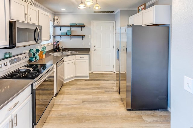 kitchen featuring white cabinets, visible vents, stainless steel appliances, and a sink