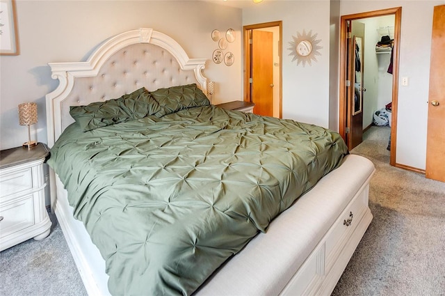 bedroom featuring carpet floors, a closet, and a spacious closet