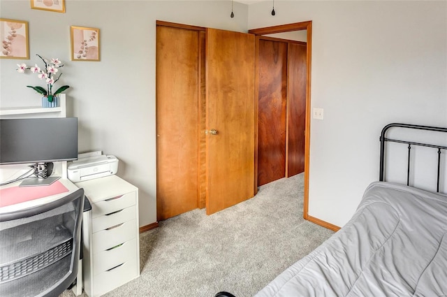 bedroom with light carpet and baseboards