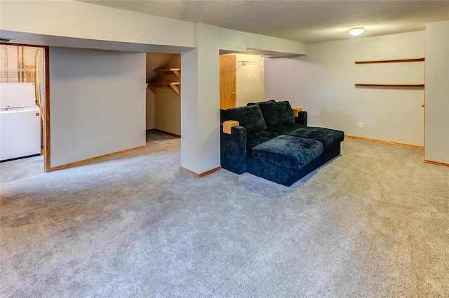 interior space featuring a textured ceiling, carpet flooring, washer / dryer, and baseboards