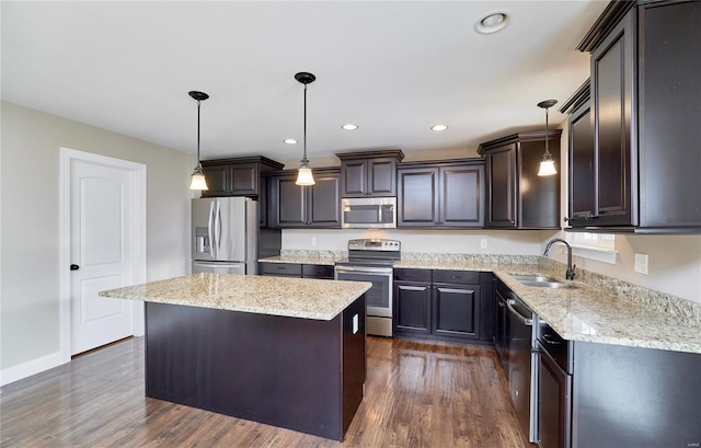 kitchen featuring stainless steel appliances, dark wood-style flooring, a sink, and a center island