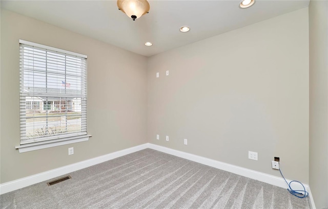 carpeted empty room with recessed lighting, visible vents, and baseboards