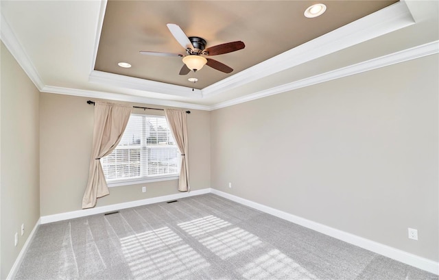 unfurnished room featuring light carpet, baseboards, ornamental molding, a tray ceiling, and recessed lighting