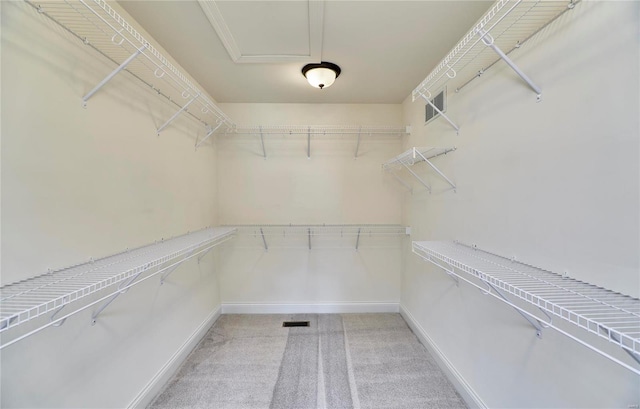 walk in closet with light carpet and visible vents