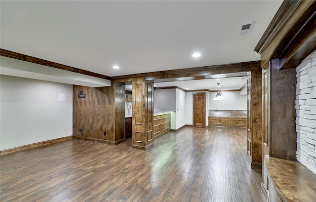 interior space featuring wooden walls, recessed lighting, dark wood-style flooring, baseboards, and crown molding