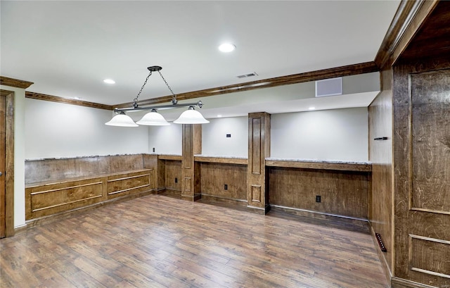 unfurnished room featuring visible vents, a wainscoted wall, ornamental molding, wood finished floors, and recessed lighting