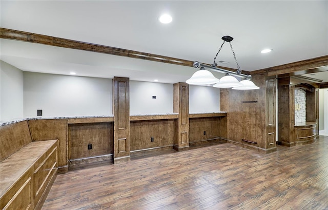 interior space with dark wood-style floors, recessed lighting, a wainscoted wall, and brown cabinets