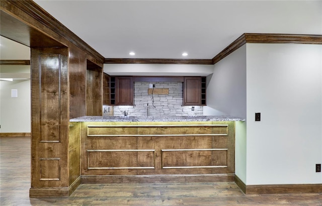 bar with recessed lighting, dark wood-type flooring, baseboards, decorative backsplash, and crown molding