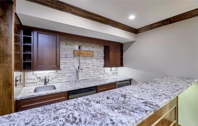 kitchen featuring light stone counters, a sink, backsplash, dishwasher, and open shelves