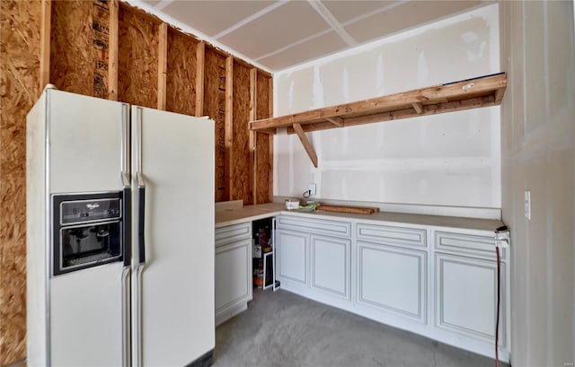 kitchen with white fridge with ice dispenser and light countertops