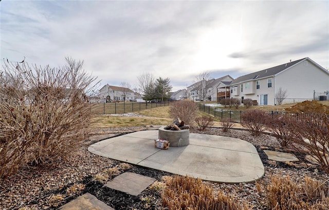 view of yard with central AC unit, a residential view, fence, and a patio