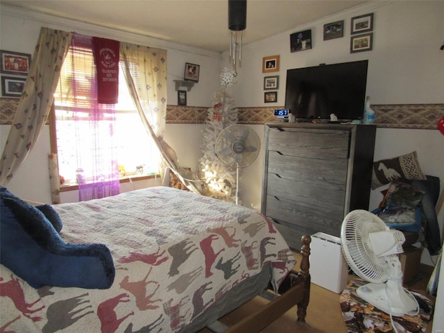 bedroom featuring multiple windows and crown molding