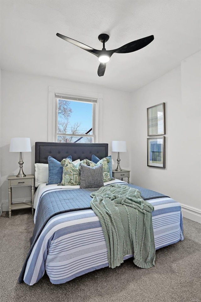 bedroom featuring baseboards, a ceiling fan, and carpet flooring