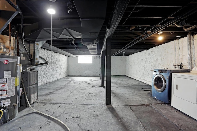 below grade area with gas water heater and washing machine and clothes dryer